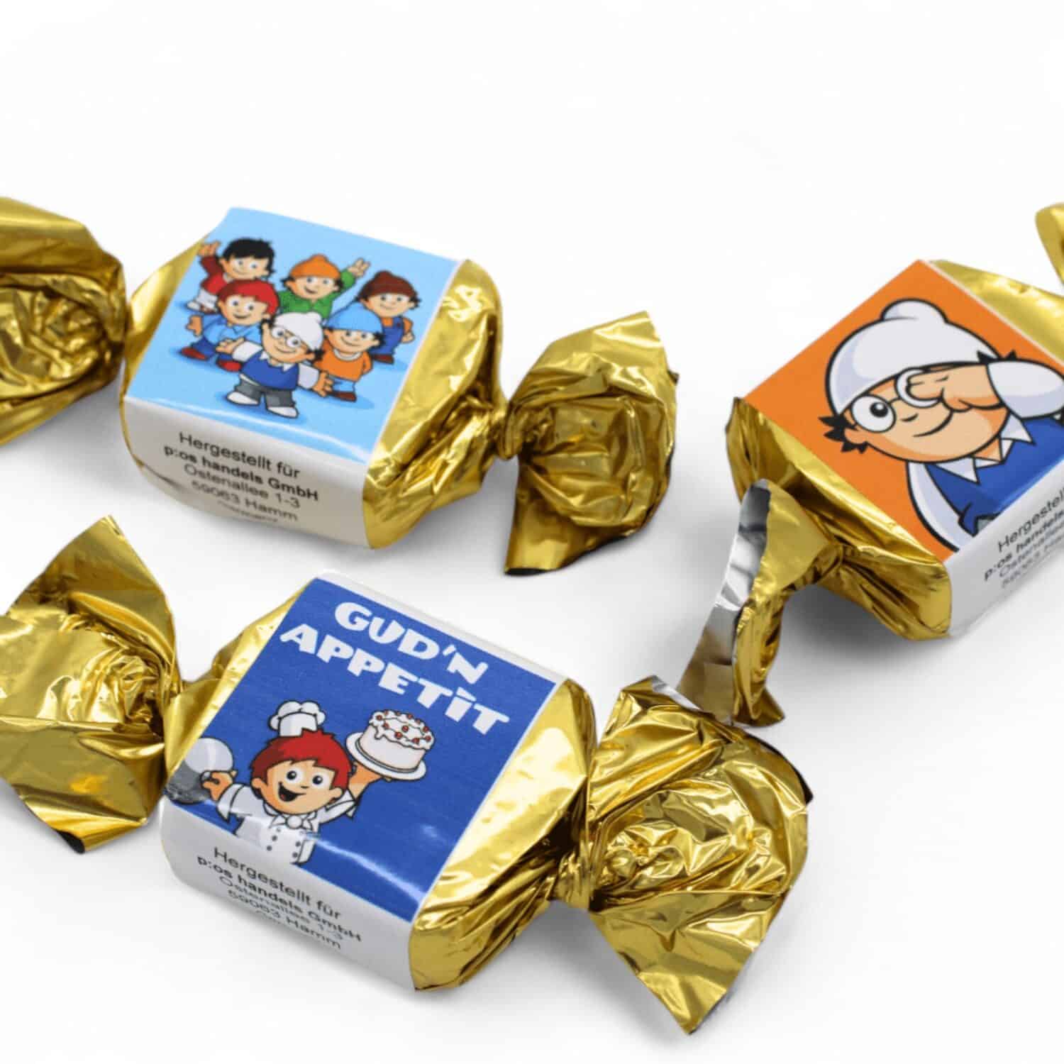 Drei Mainzelmännchen-Motive der in goldenem Papier verpackten Nougat Happen